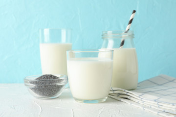 Glass of chia milk and chia seeds on blue background, space for text. Closeup