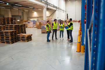 Warehouse meeting, managers and workers	