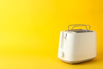 Toaster for bread on yellow background, space for text