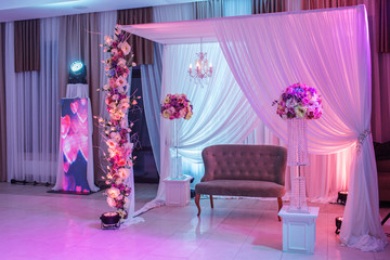 wedding decor with classic retro sofa and white, pink flowers.
