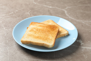 Plate with tasty toasts on grey background, space for text