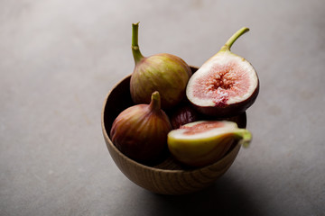 Fresh ripe figs in a bowl closeup on a dark background
