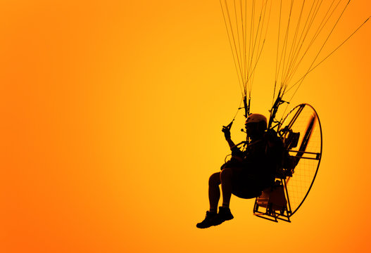 the sport paramotor and orange sky