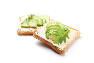 Toasts with butter, avocado, arugula and sesame isolated on white background