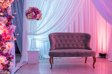 wedding decor with classic retro sofa and white, pink flowers.