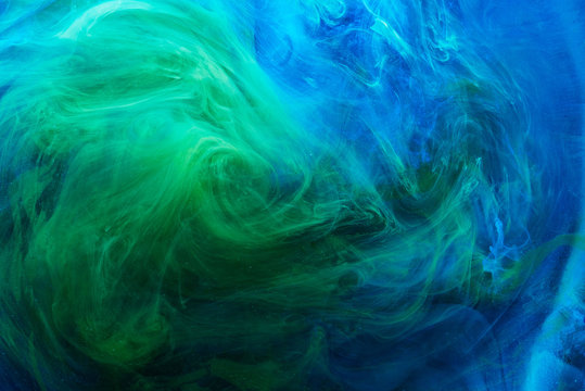 Abstract blue green background, underwater art. Colorful swirling paint smoke