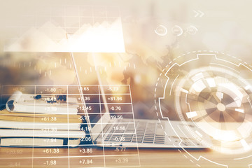 Stock market graph and table with computer background. Double exposure. Concept of financial analysis.