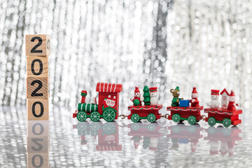 The toy train on the desk and the building block with the word 2020