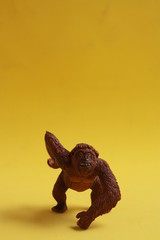 orangutan shaped plastic toy in color background
