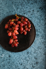 Wine grapes on blue background. Copyspace.