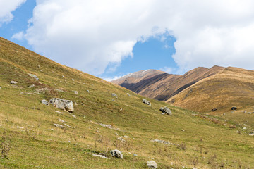 The slopes  of the mountains against the sky and clouds in Svaneti in the mountainous part of Georgia