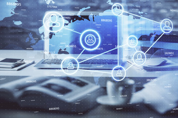Computer on desktop with social network theme icon. Multi exposure. Concept of international connections.
