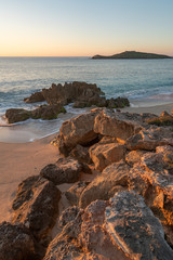 Porto Covo beach at sunset with Ilha do Pessegueiro Island on the background, in Portugal