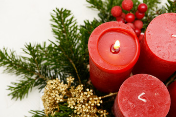 Burning red candles on advent arrangement at Christmas time