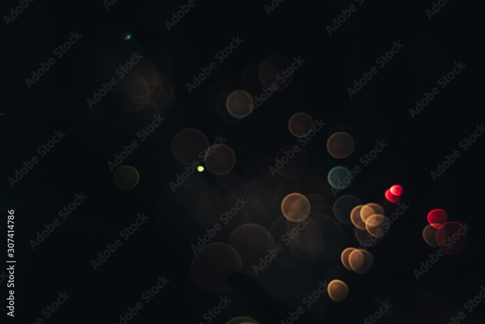 Poster beautiful magic gold bokeh background in the darkness.