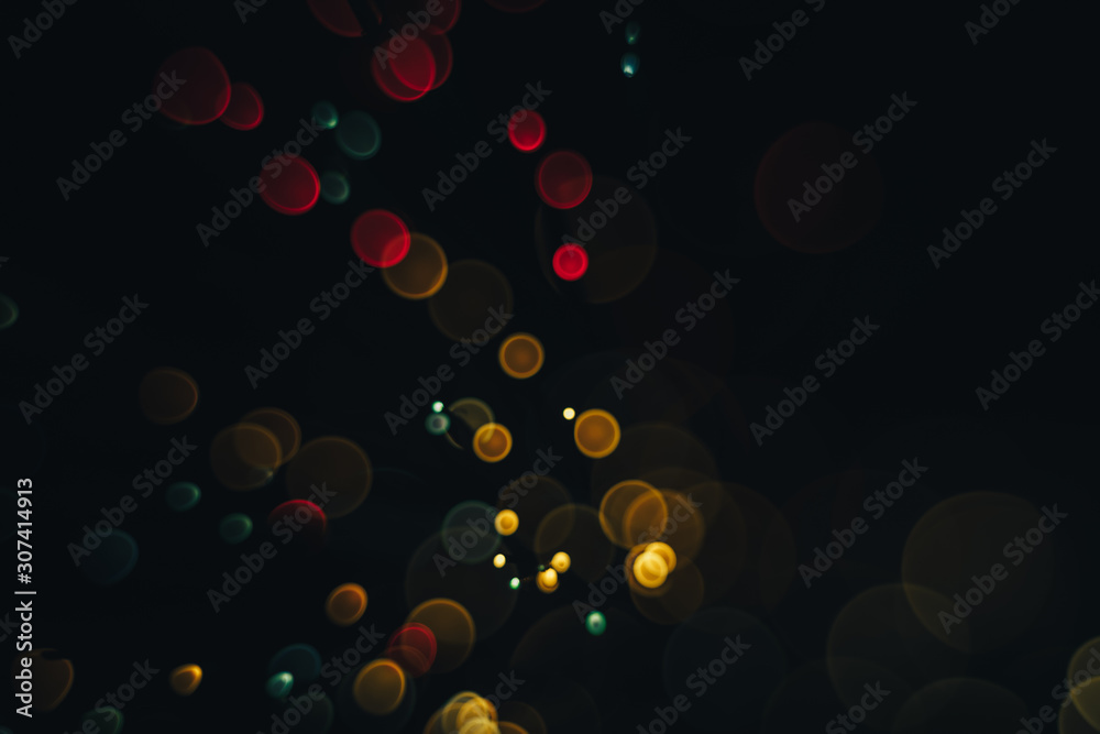 Poster beautiful magic gold and red bokeh background in the darkness.
