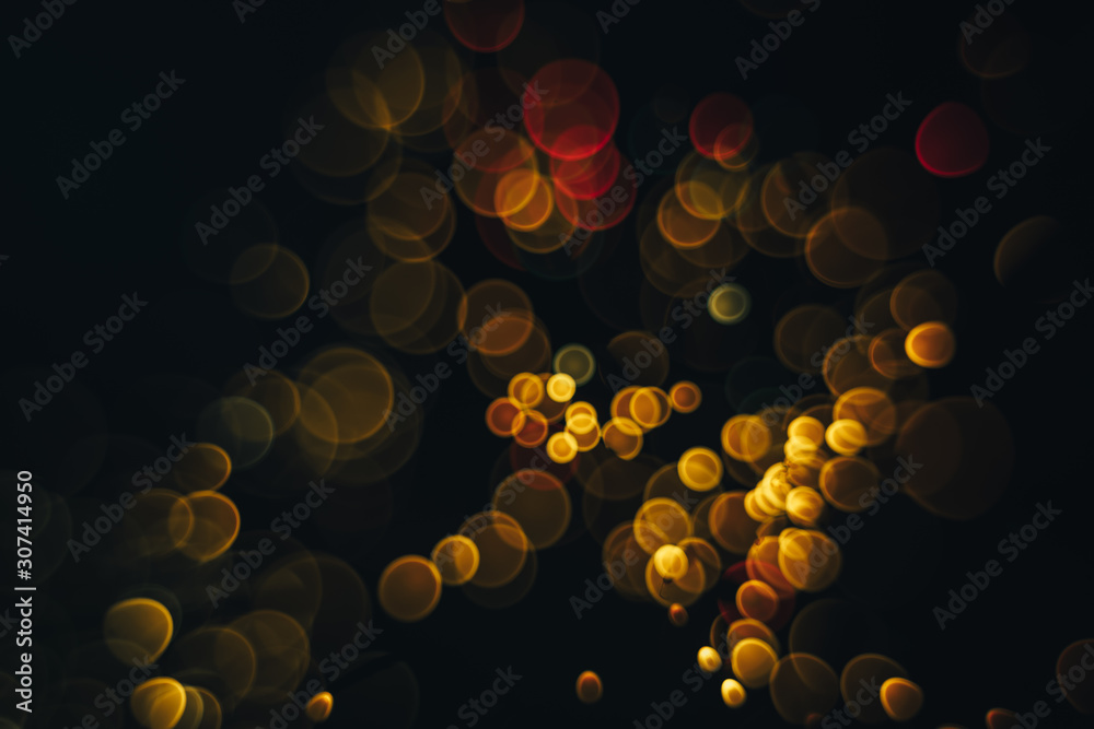 Poster beautiful magic gold and red bokeh background in the darkness.