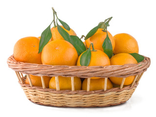 Fresh tangerines in a basket isolated on white