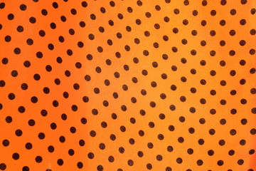 Black round dot on bright yellow fabric background. A weave of cloth texture surface detail with natural light. Women dress, fashion wallpaper or backdrop with copy space for text