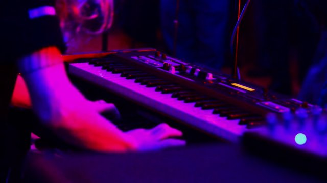 Piano player in the club. Real time.