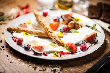 Cheese platter for two served on a plate in restaurant