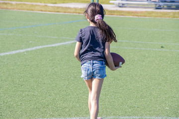 girl throwing a football