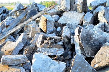 Recycling and reuse crushed concrete rubble, asphalt, building material, blocks. Broken concrete slabs at construction site. Сoncrete rubble from demolition at landfill. Hardcore waste recycling