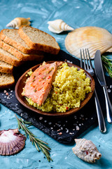 Grilled salmon with couscous and sauce, selective focus