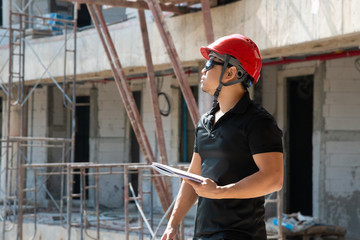 Naklejka na ściany i meble construction engineer in red hardhat