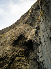 Looking up on the Hálsanefshellir Cave, with the beautiful basalt columns in detail. On the Reynisfjara Black Sand Beach. South Coast of Iceland.