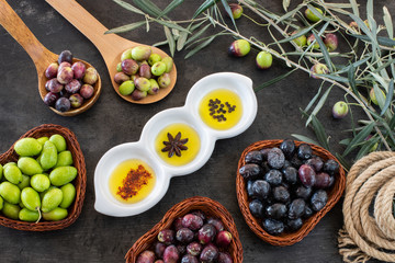 Many types of olive like green & black and olive oil at the black background