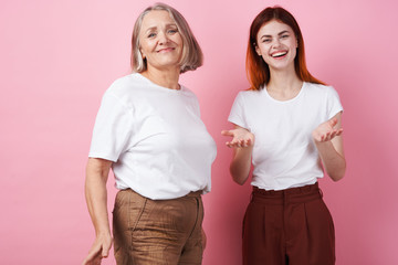 Grandmother and granddaughter are standing nearby