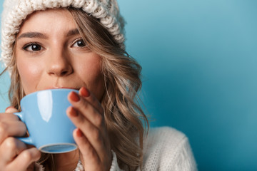 Portrait of caucasian happy woman drinking tea and looking at camera