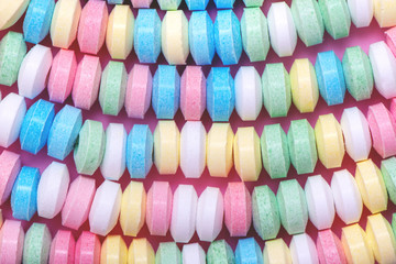Pastel background made of candy necklace.
