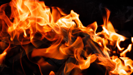 Texture of a flame of fire on a black background. burning fire in a stove closeup