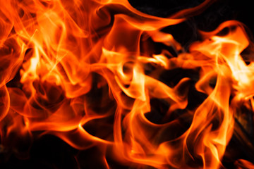 Texture of a flame of fire on a black background. burning fire in a stove closeup