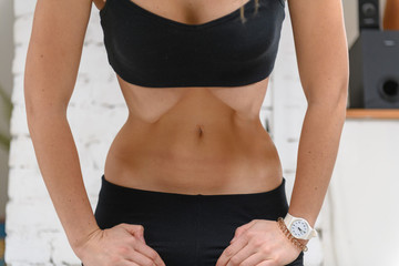 Young woman doing abdominal vacuum exercise, nauli wave
