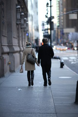 Couple holding hands while walking in New York City #1