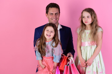 Shopping and family concept. Girls and man with happy faces