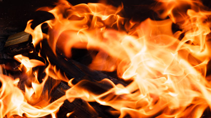 Texture of a flame of fire on a black background. burning fire in a stove closeup