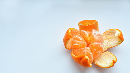peeled tangerine on a white background.Orange fruits and peeled segment Isolated. Pile of orange...