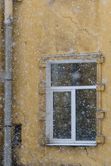 View to courtyard in Saint-Petersburg from window in winter time, snow fall