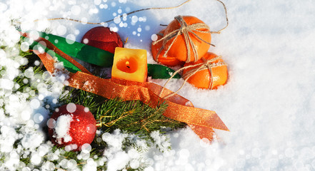 Fototapeta na wymiar New Year and Christmas concept. Tangerines and spruce branch on fluffy snow. Russian winter. Attributes of the New Year, Christmas. New Year 2020