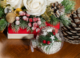 Close-up of Christmas bouquet with flowers and spruce with snow.