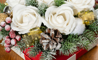 Close-up of Christmas bouquet with flowers and spruce with snow.