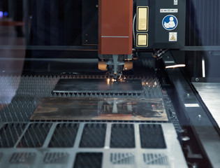 CNC fiber laser cutting machine cutting metal sheet. Industrial metalworking machinery