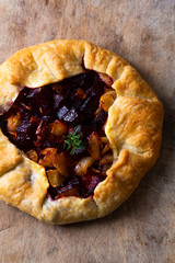 Healthy food concept preparation for Homemade rustic organic roasted beets and onion caramel galette pie with copy space