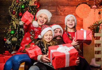 Obraz na płótnie Canvas expectation. open xmas present. gifts from santa. santa father at decorated tree. cheerful mother love children. small girls sisters with parents. Happy family celebrate new year and Christmas