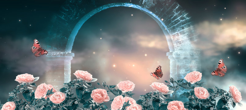 Fantasy fabulous panoramic banner background of magical night sky with shining stars, clouds and roses garden and peacock eye butterflies against magical mirage of old stone ruins of ancient gate