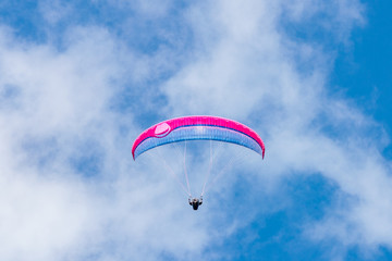 Beautiful shot of a person paragliding in the sky - extreme concept